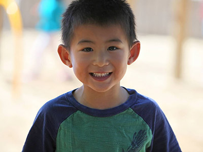 boy on playground smiling
