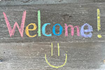 the word Welcome written in multi color chalk